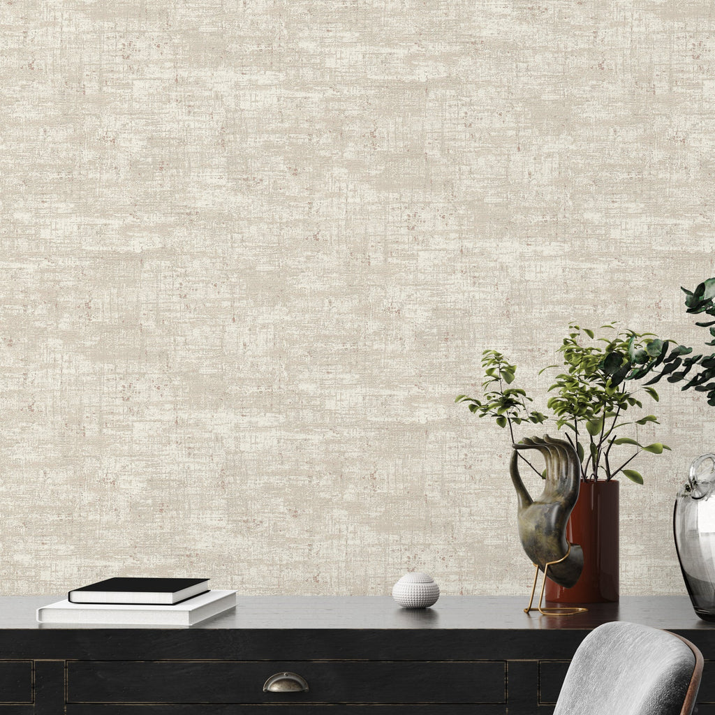 Beige textured wallpaper with a desk and decorative items in the foreground