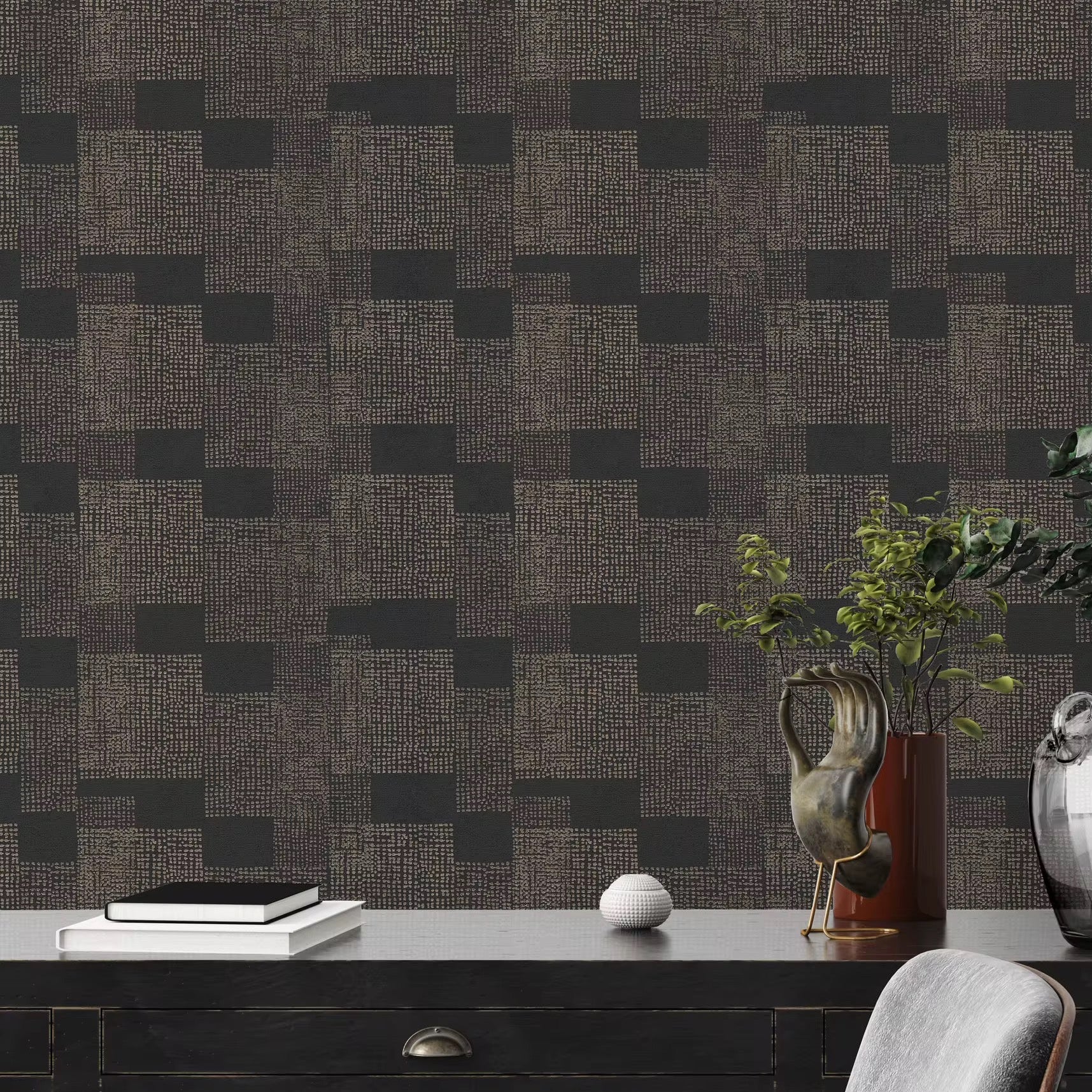 Dark geometric patterned wallpaper in a room with a desk and decorative items.