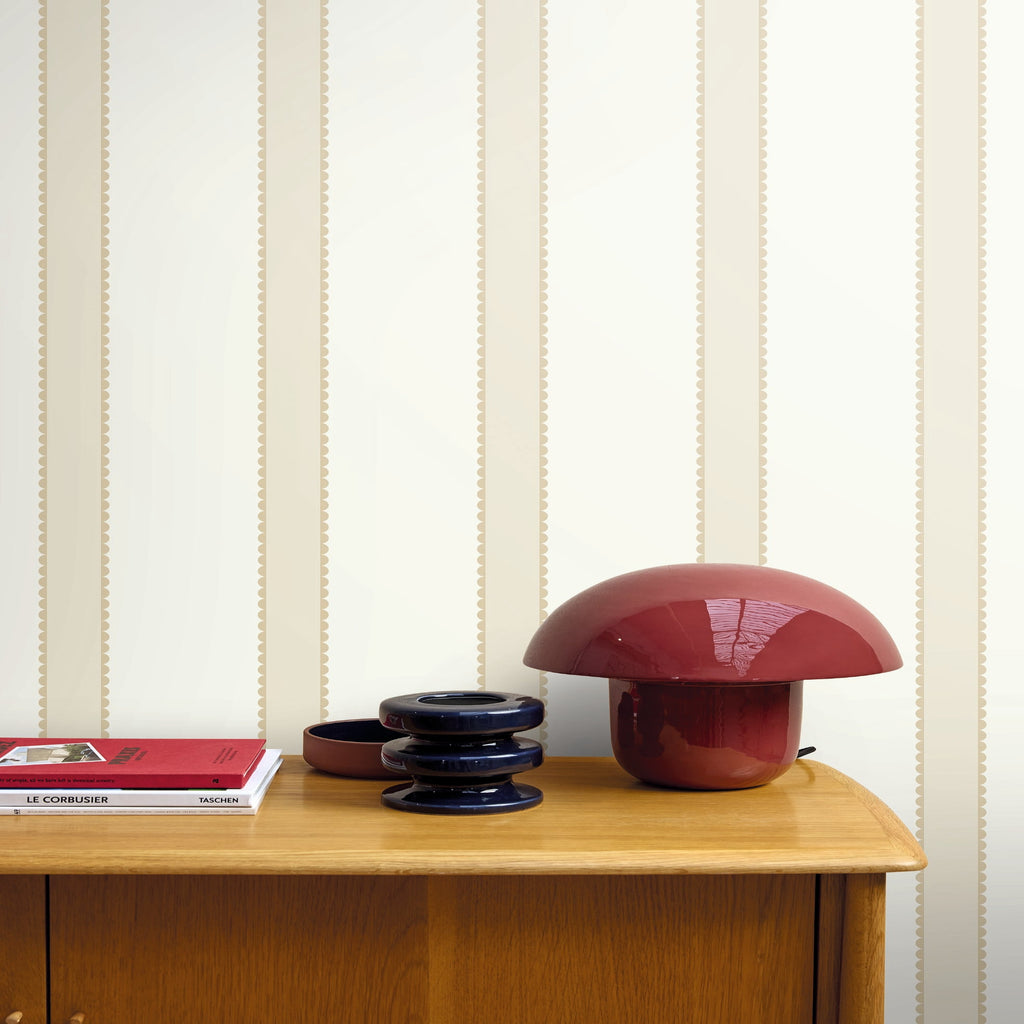 Mushroom-shaped lamp on a wooden surface with striped wallpaper in the background