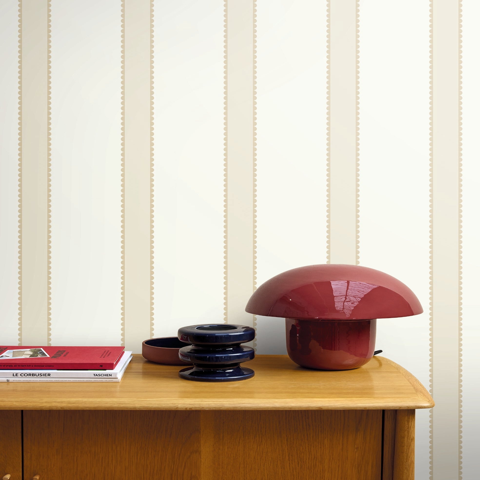 Mushroom-shaped lamp on a wooden surface with striped wallpaper in the background