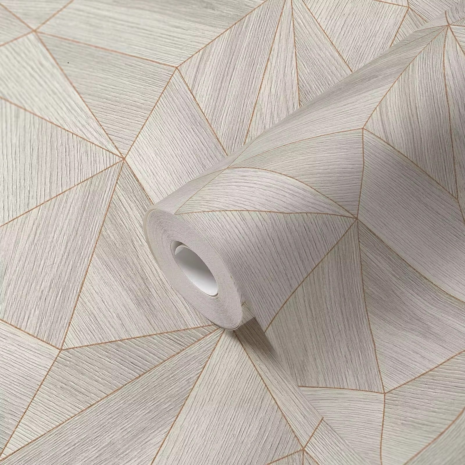 Roll of geometric patterned wallpaper on a matching background