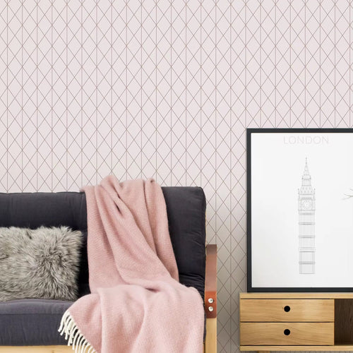 Living room with pink patterned wallpaper, gray sofa, pink throw blanket, and framed picture.