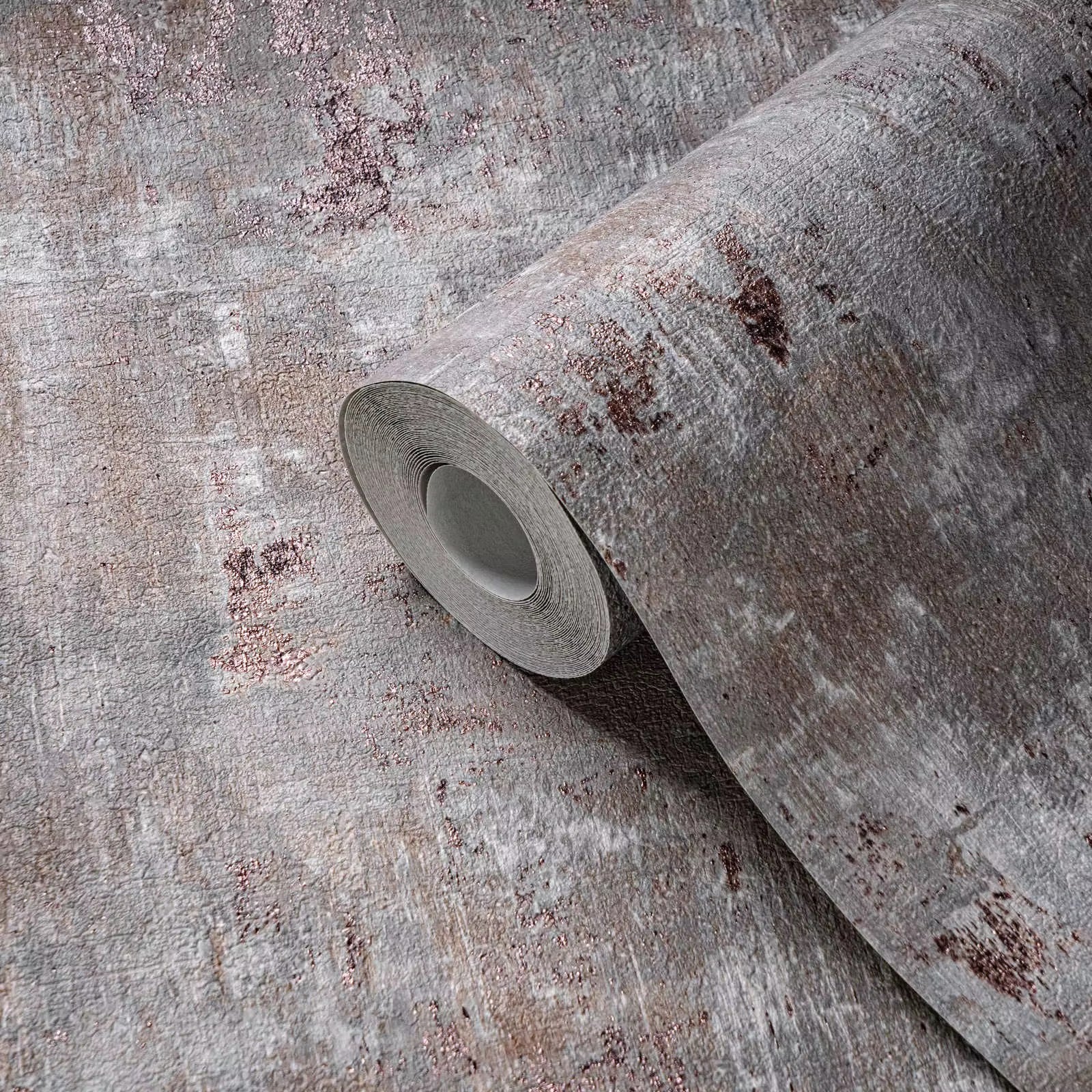 Roll of textured wallpaper on a textured surface