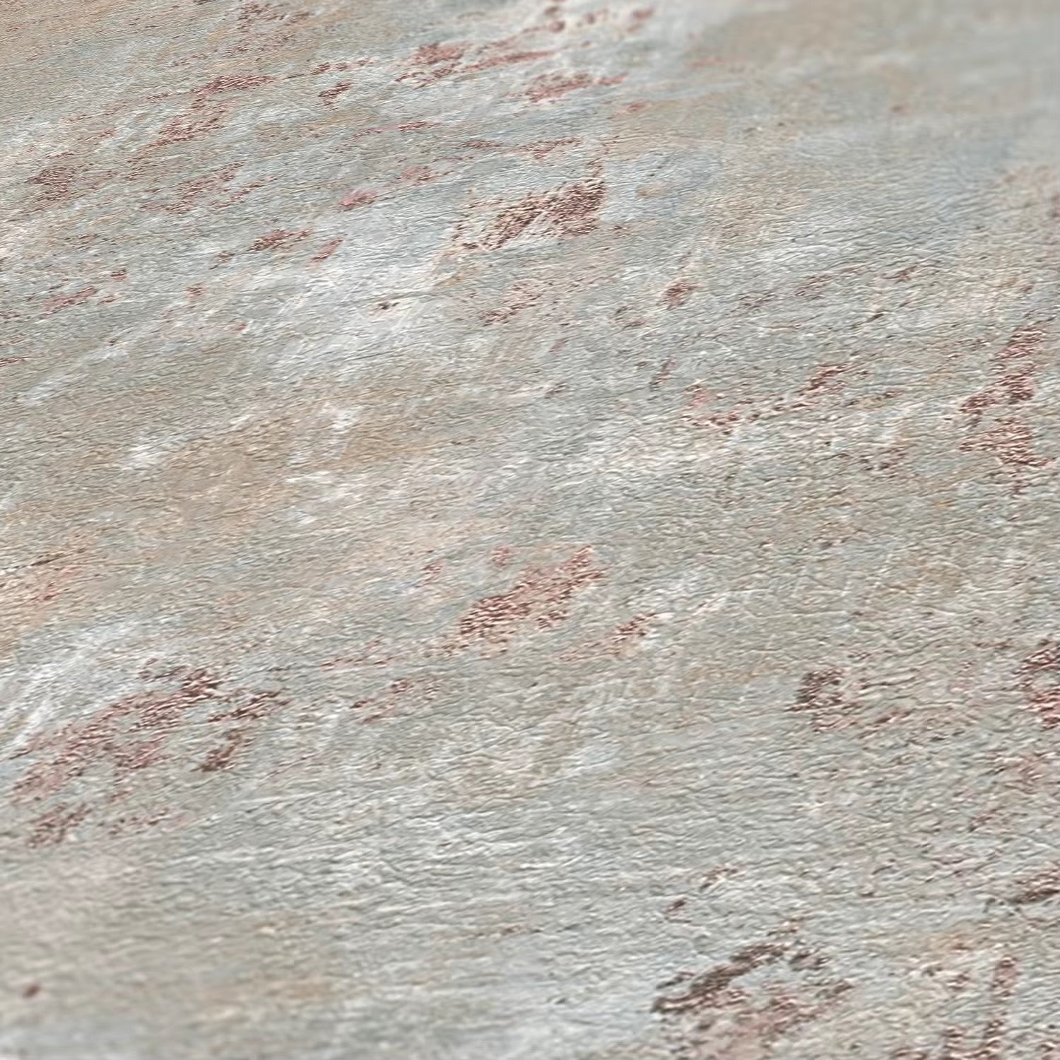 Close-up of a textured stone surface with variations in color.