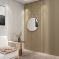 Modern interior with a round mirror on a acoustic slat wall, white chair, and small table.