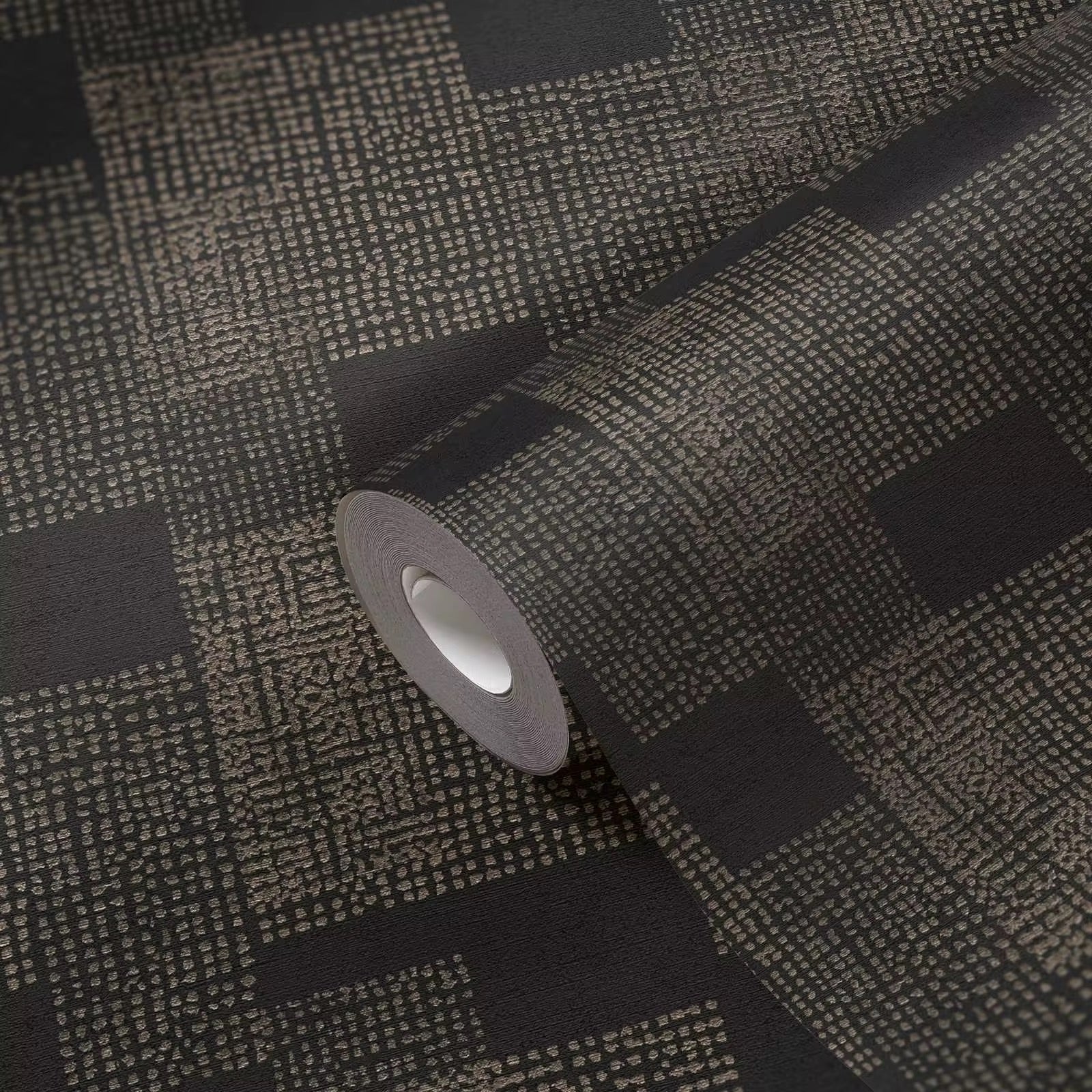 Roll of black textured wallpaper with a pattern