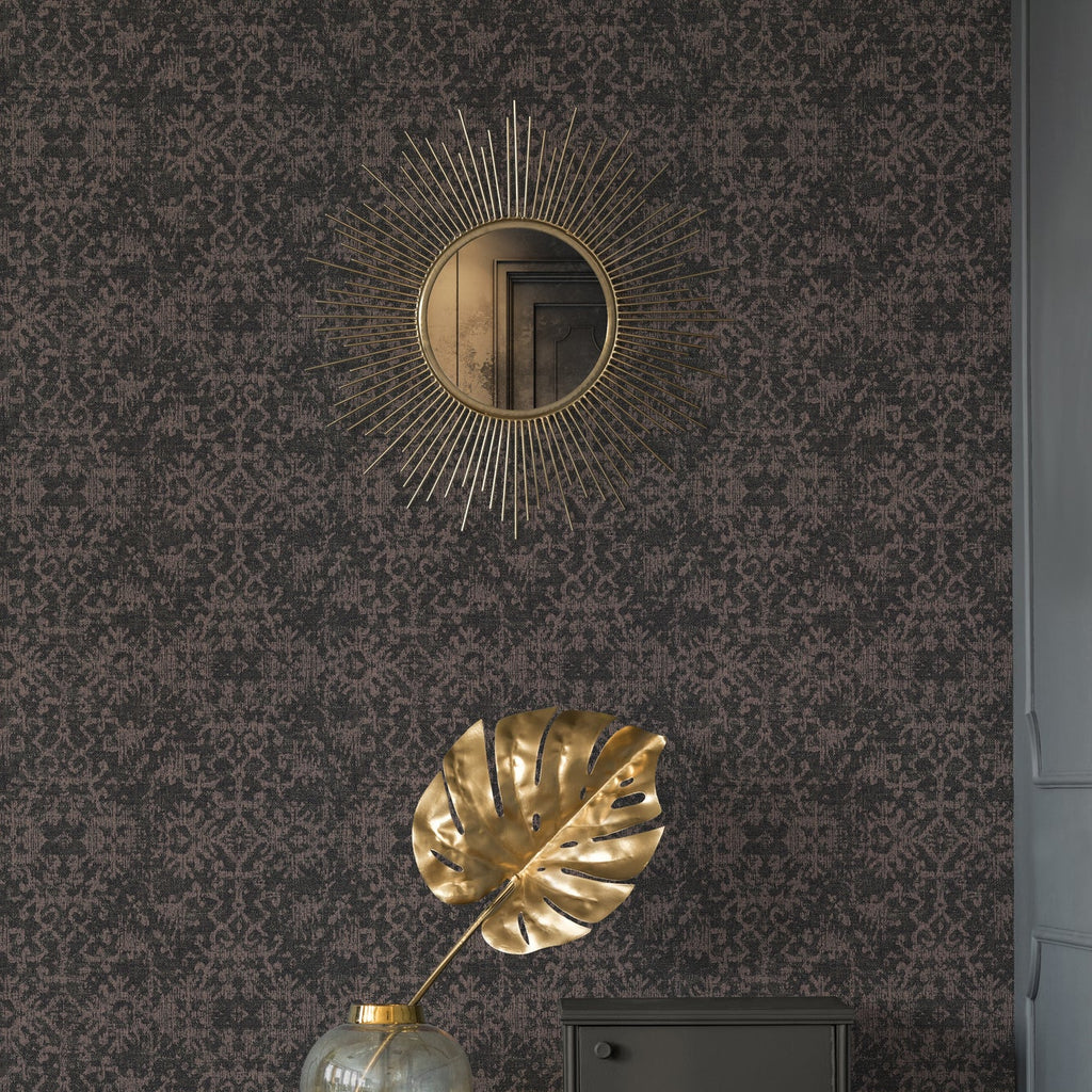 Decorative gold leaf and mirror on a patterned wallpaper 