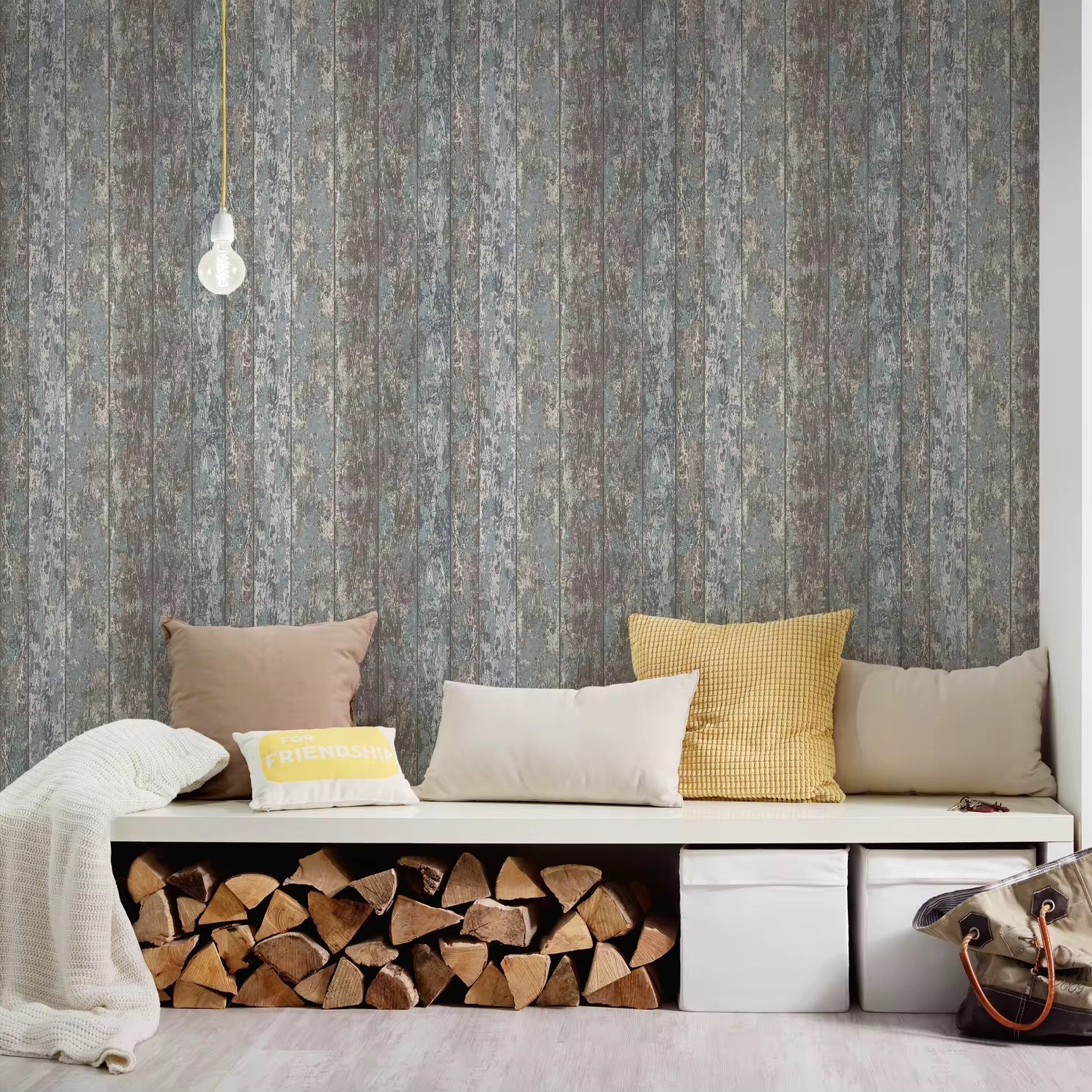 Bench with stacked firewood and colorful pillows against a textured wallpaper