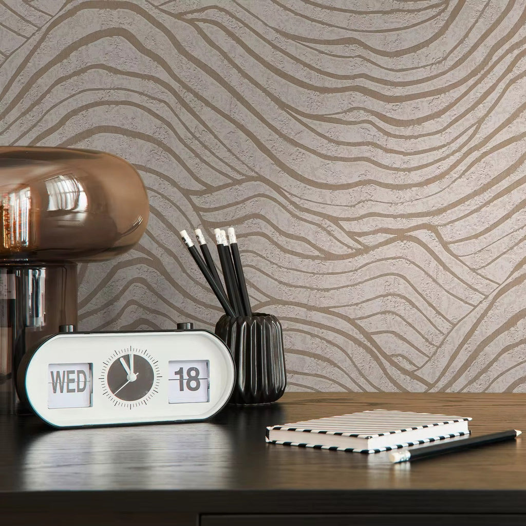 Desk setup with a clock, pen holder, and notebook against a wavy patterned wallpaper