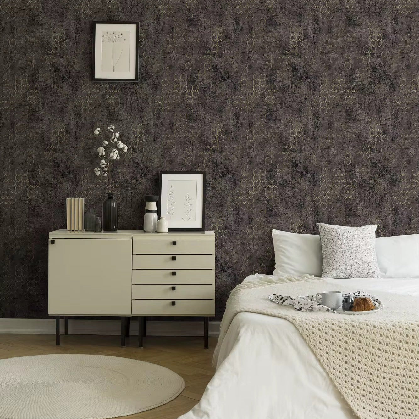 Neatly arranged bedroom with a dresser and bed against a patterned wall.