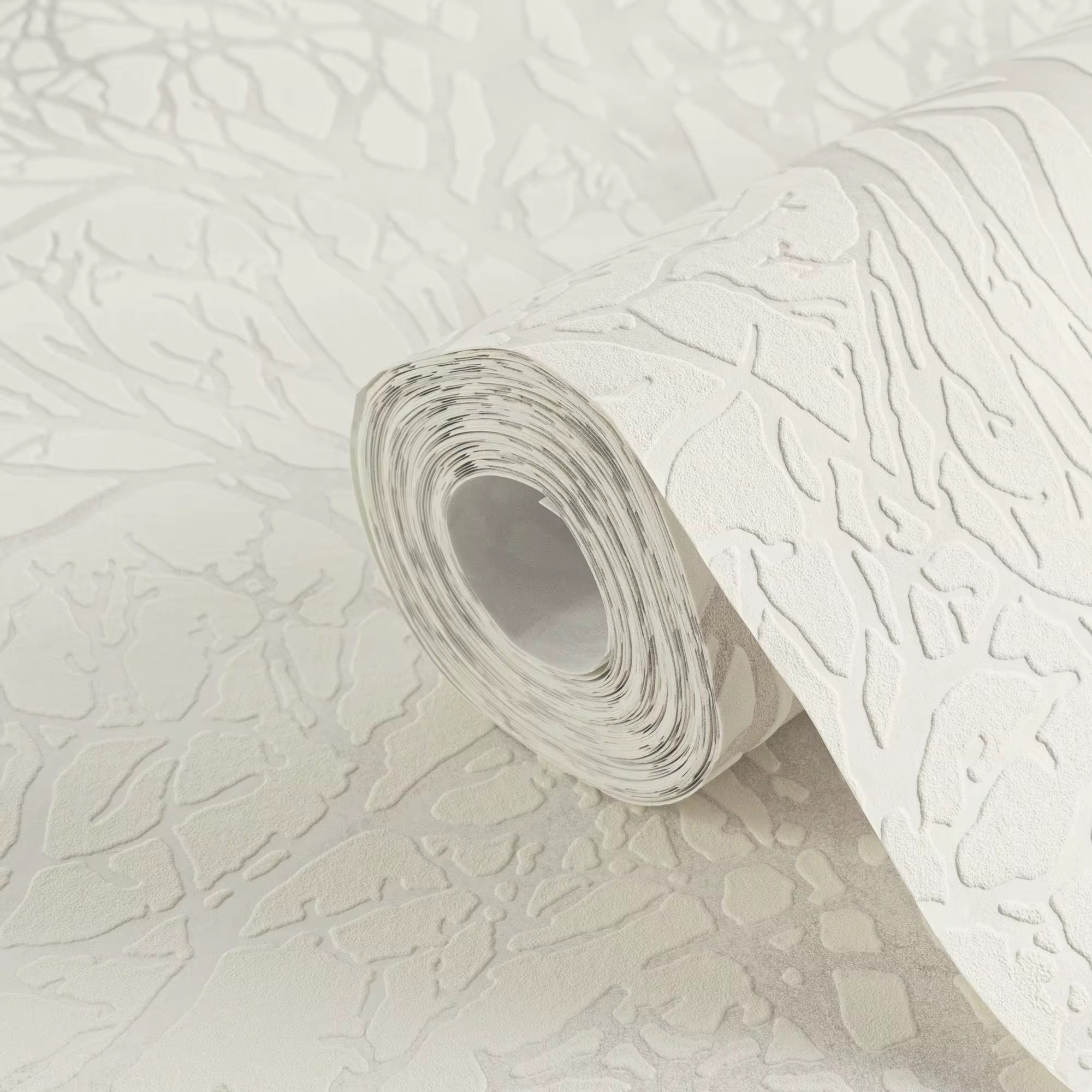 Roll of textured white wallpaper on a matching background
