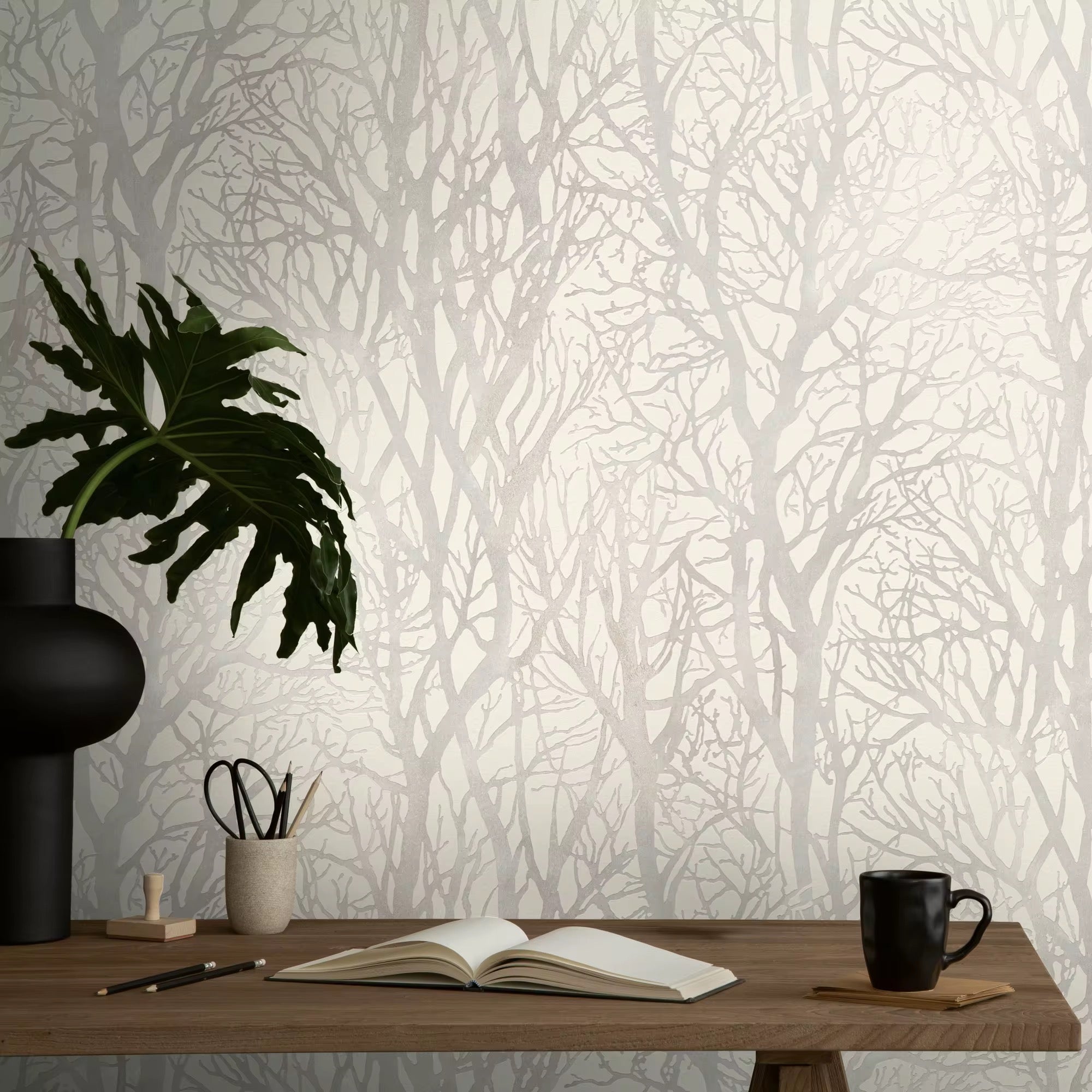 Wallpaper with tree design, desk with items against the wall