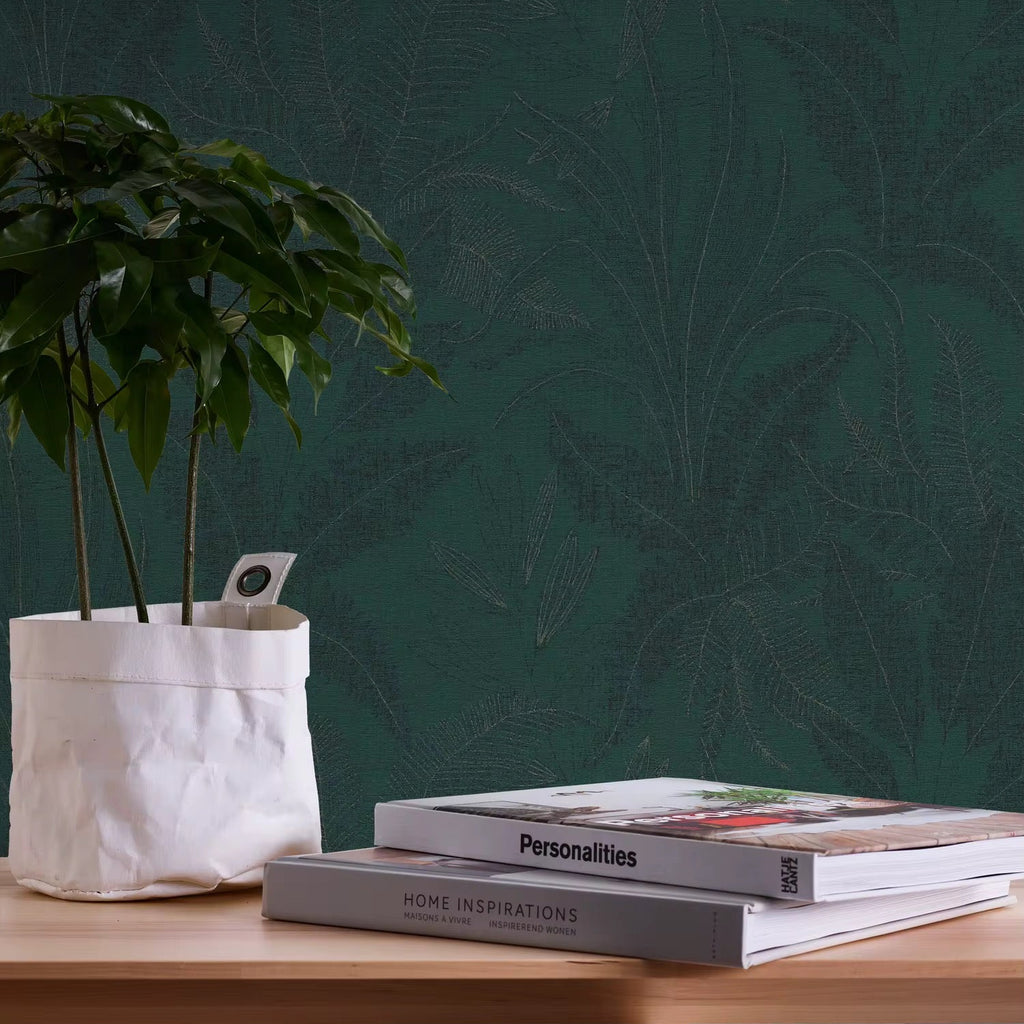 Two books titled 'Personalities' and 'Home Inspirations' on a wooden surface with a plant in the background.